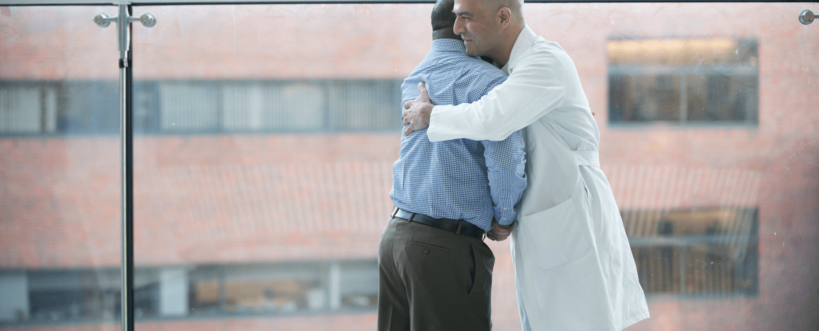 Doctor hugging patient