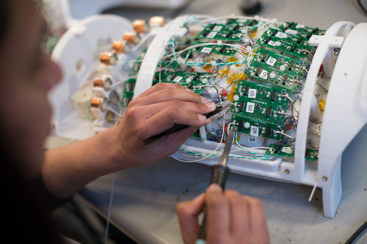 Researcher working on a complicated machine