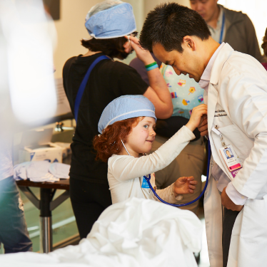 Little girl listening to a doctor's heartbeat